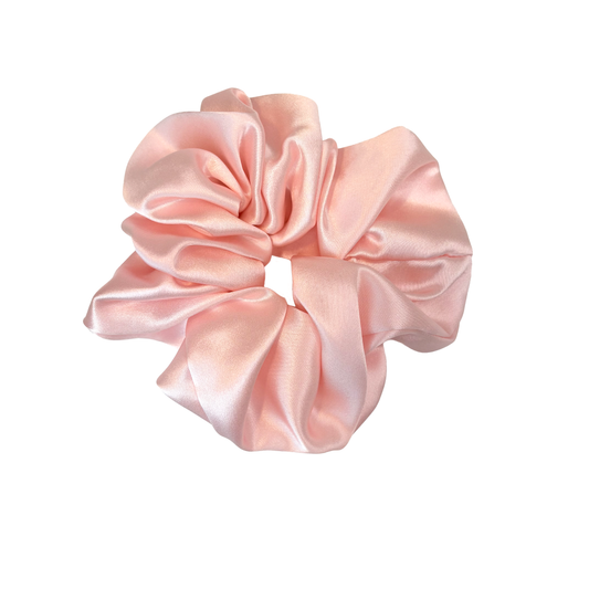 Pink satin scrunchie on a white background