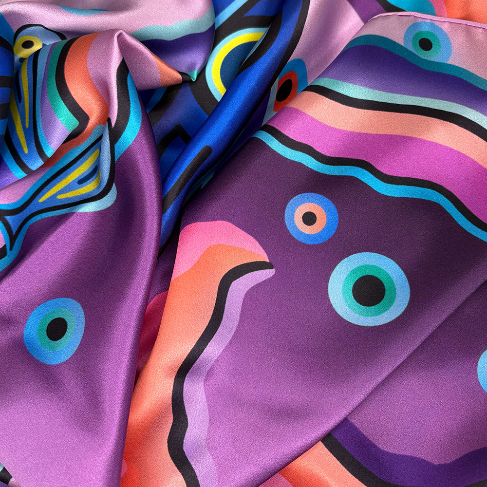 Colorful abstract patterned fabric with vibrant colors on a purple background