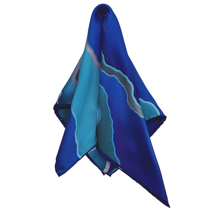 Blue and green patterned scarf on a white background