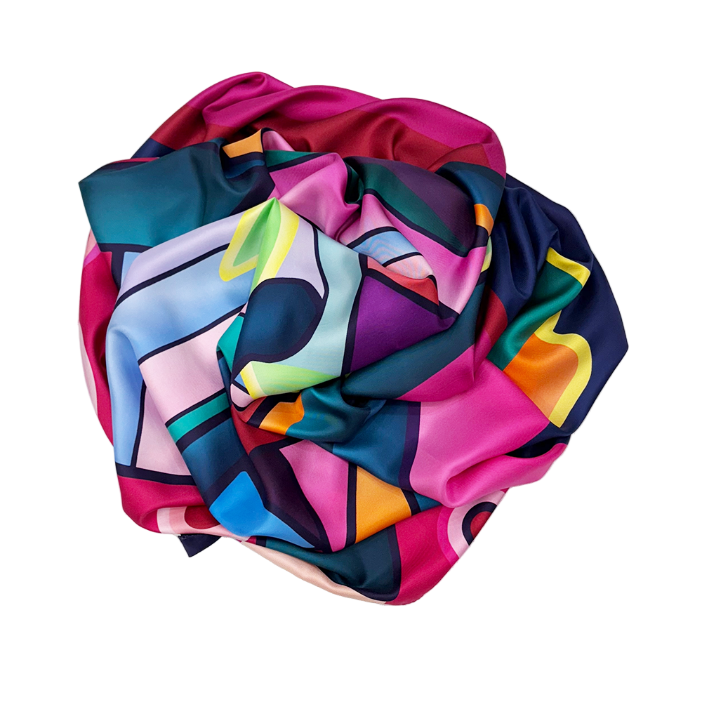 Colorful abstract patterned silk scarf on a white background