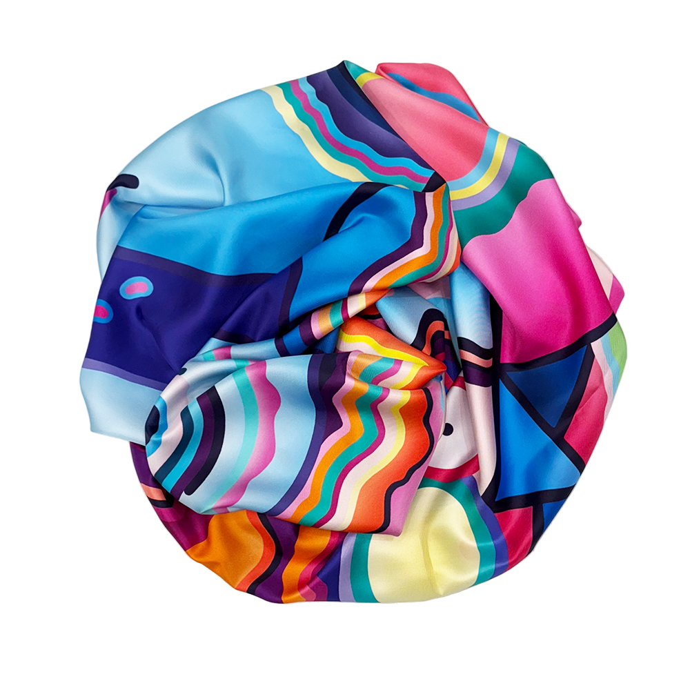 Colorful abstract-patterned silk scarf on a white background