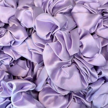 Close-up of multiple purple satin scrunchies.