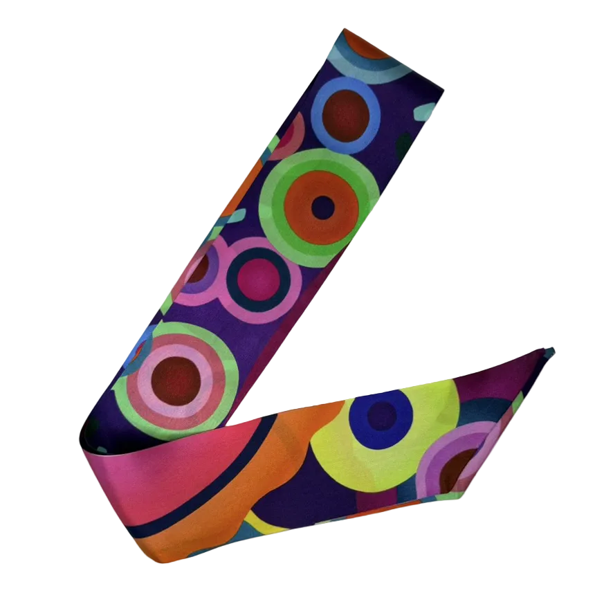 Colorful circular patterned headband on a white background