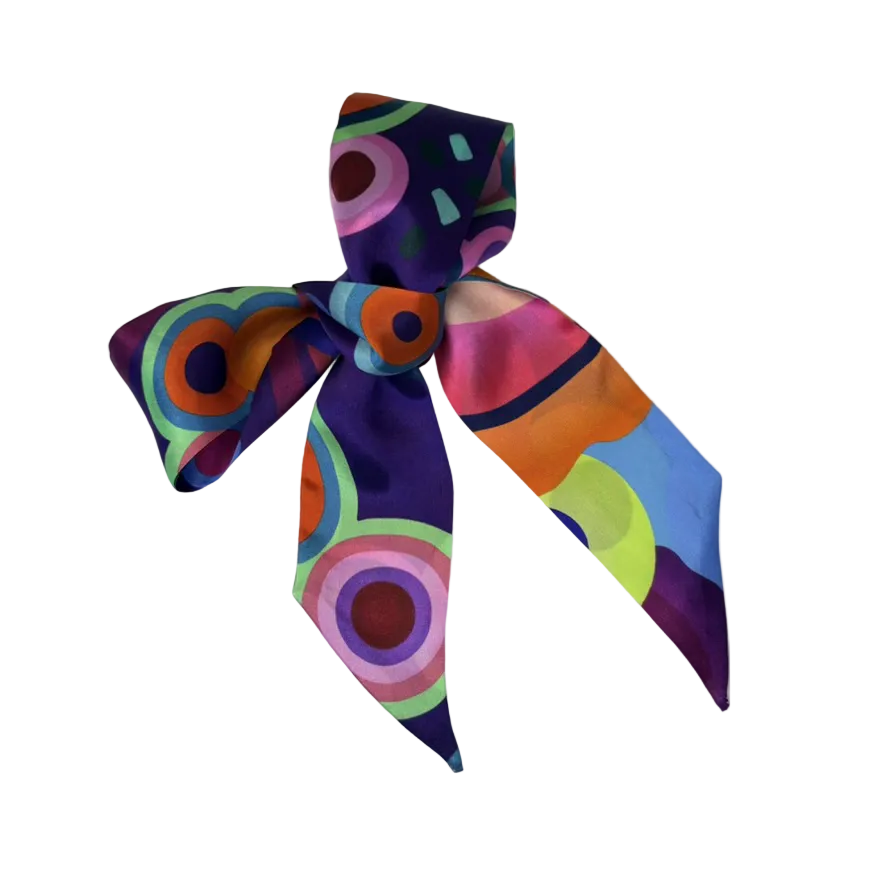 Colorful bow-shaped scarf with geometric pattern on a white background