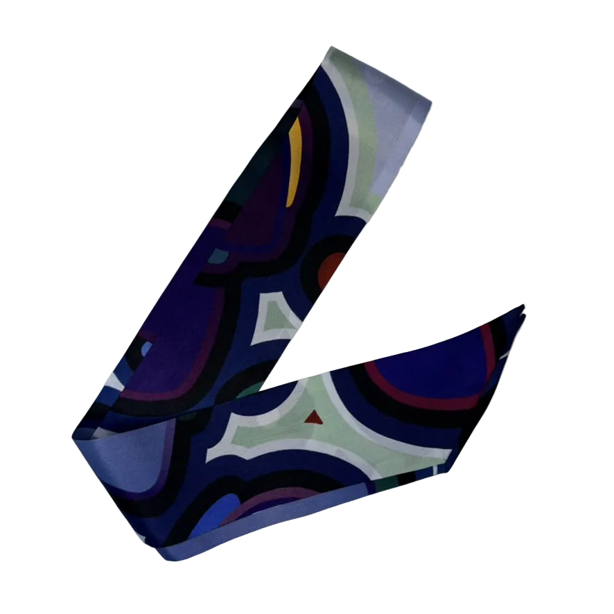 Colorful abstract patterned silk twilly scarf on a white background